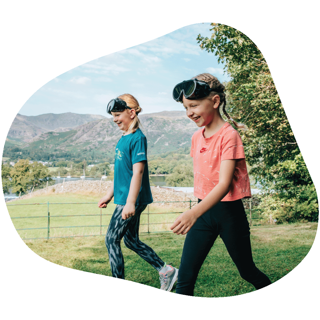 Two children walking in a field